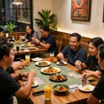 Exciting dining atmosphere at POKERSERI with friends enjoying card games and Indonesian cuisine.