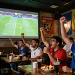 Cakhiatv fans enjoying a thrilling football match at a lively pub.