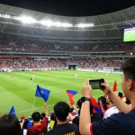 Experience thrilling live koora moments with fans celebrating exciting football matches in a vibrant stadium.